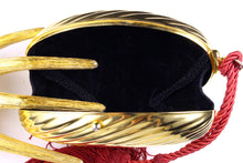 Golden oval-shaped clutch with tassel