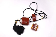 YVES SAINT LAURENT Opium perfume pendant