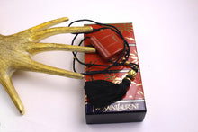 YVES SAINT LAURENT Opium perfume pendant