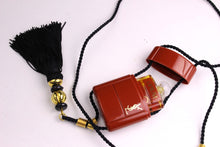 YVES SAINT LAURENT Opium perfume pendant