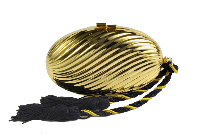 Golden oval-shaped clutch with tassel