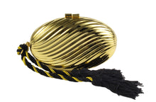 Golden oval-shaped clutch with tassel