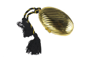 Golden oval-shaped clutch with tassel