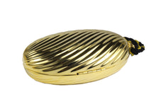 Golden oval-shaped clutch with tassel