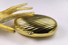 MENBUR golden metal oval-shaped clutch