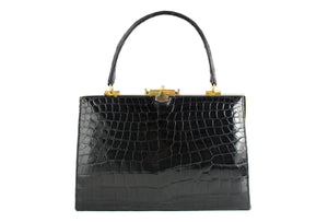 Black crocodile skin handbag with metallic frame