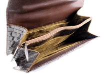 Brown crocodile skin handbag with flap and decorative clasp