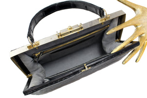 Black crocodile skin handbag with metallic frame