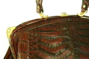 Sizable reddish-brown crocodile skin handbag