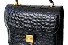 Jet black crocodile skin handbag with flap and decorative clasp