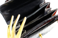 Jet black crocodile skin handbag with flap and decorative clasp