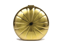 Metallic gold circular clutch with radial embossing