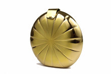 Metallic gold circular clutch with radial embossing