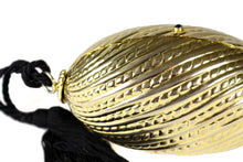 Golden egg clutch with wrist tassel