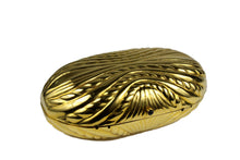 Golden metal oval-shaped clutch