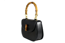 Black leather handbag with bamboo handle and lock