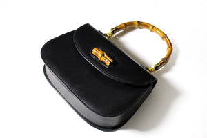 Black leather handbag with bamboo handle and lock