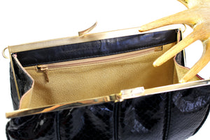 Black snake skin handbag with decorated frame