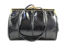 Black snake skin handbag with decorated frame