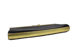 Elongated black and gold leather clutch